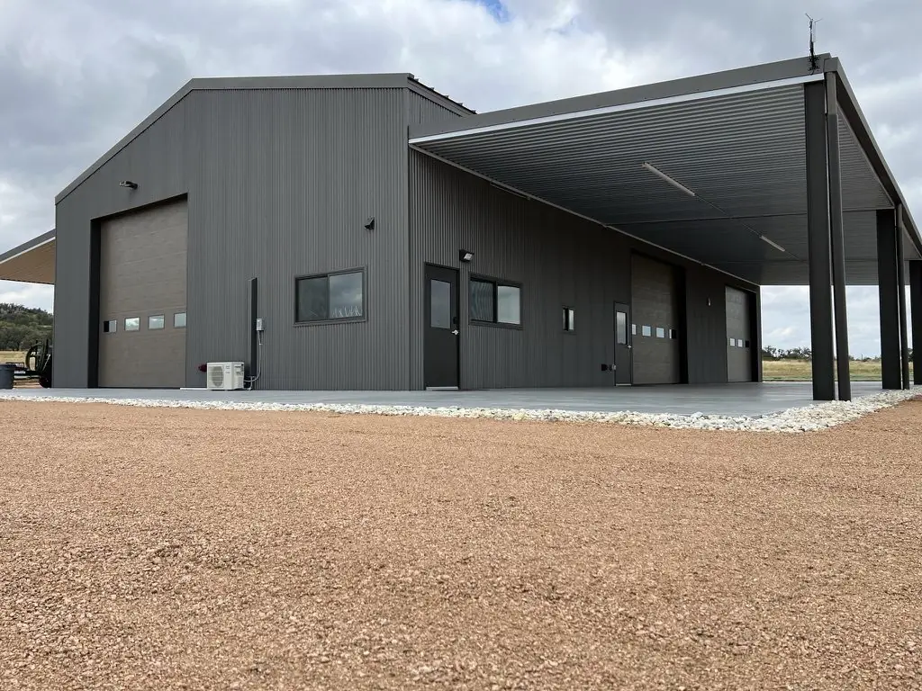 Gray steel shop with a full-length covered bay
