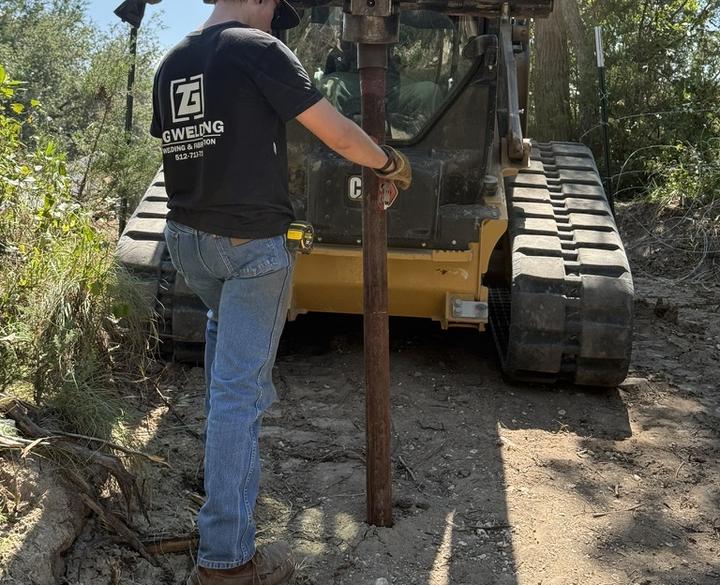 Driving a steel fence post with a skid steer