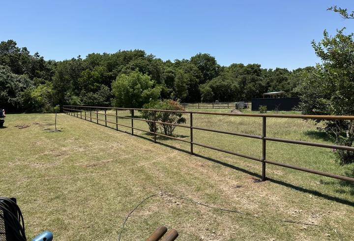 Four rail pipe fence along the pasture