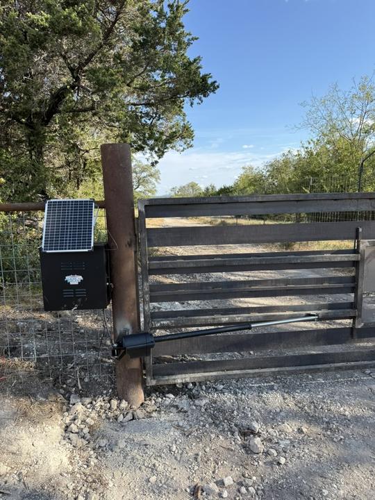 Solar powered opener on a ranch drive gate