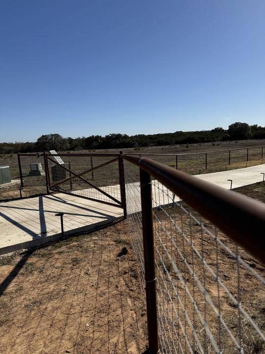 Pipe rail fence and walk gate at the entry