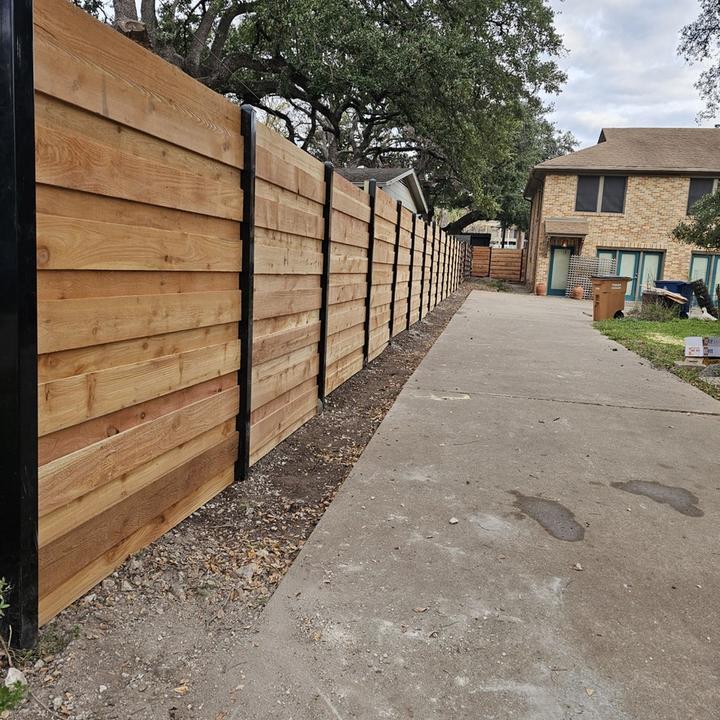 Horizontal cedar fence on black steel posts