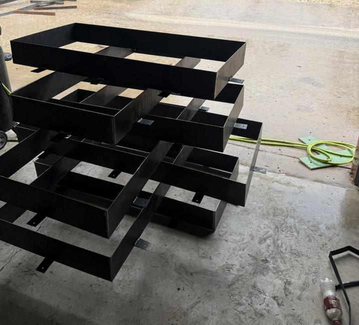 Stack of welded steel frames ready to finish