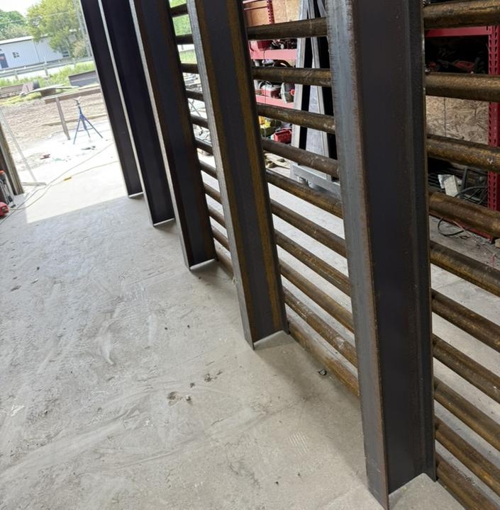 Steel beams stood up in the shop before fitting