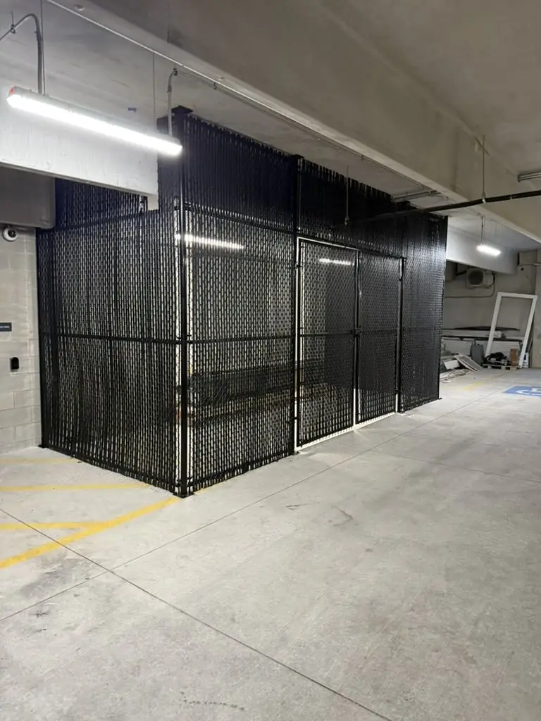 Secure steel storage cage in a parking garage