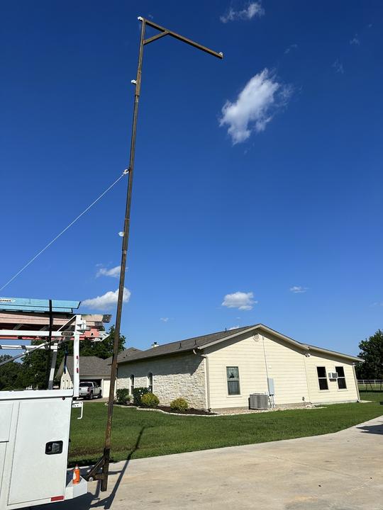 Tall steel mast mounted to a truck receiver