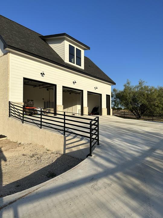 Horizontal bar rail along raised garage driveway