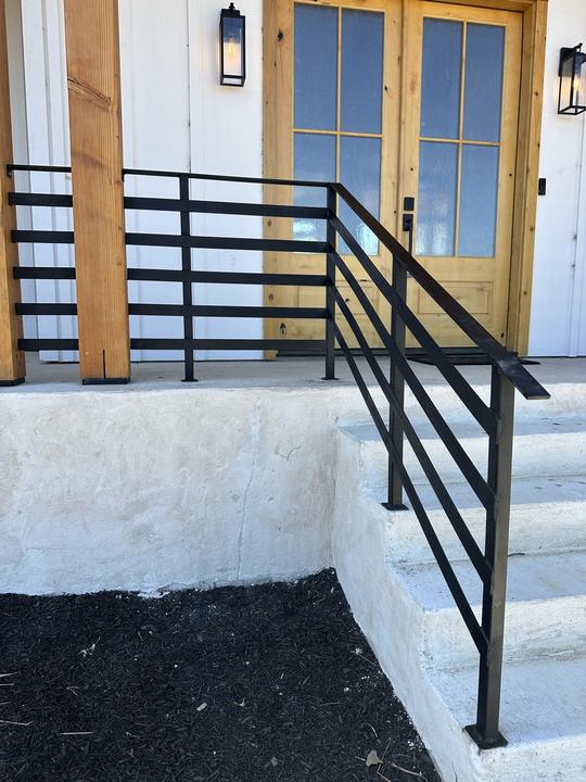 Flat bar entry stair rail tied into porch rail