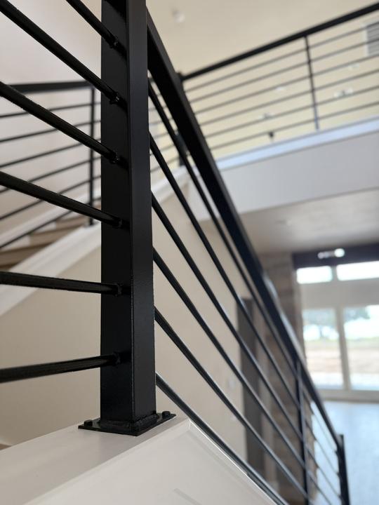 Welded post and base plate on stair rail