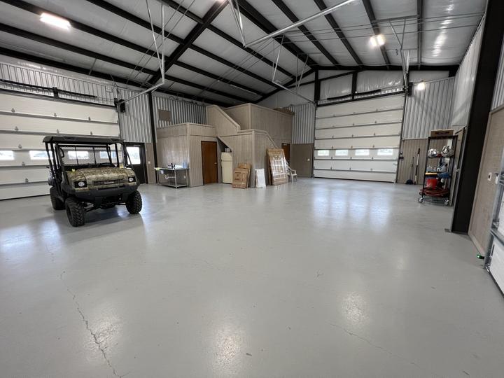 Shop interior with overhead doors and stair loft
