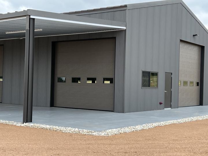 Overhead doors and man door on a finished shop