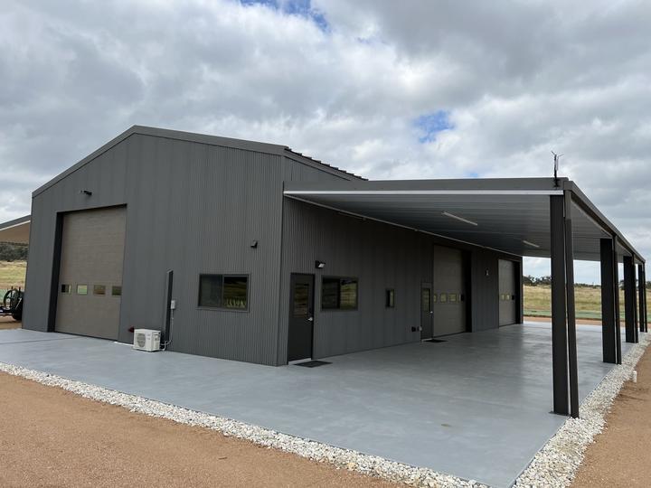 Black steel shop with full-length covered porch