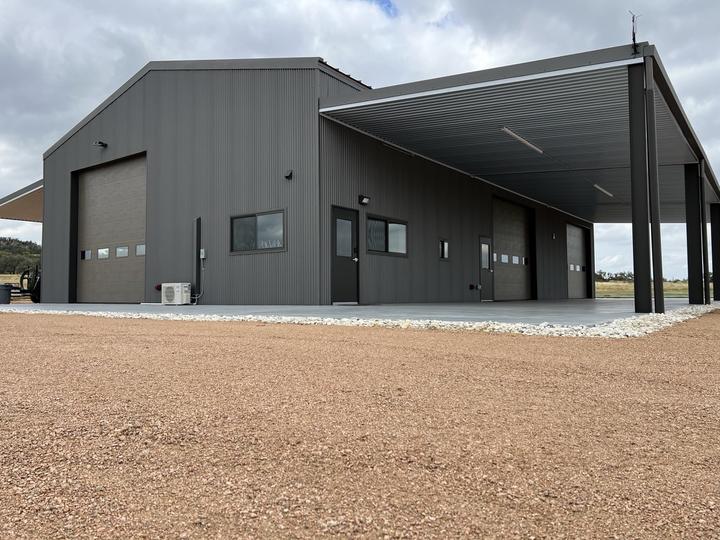 Finished steel shop, roll-up doors and wraparound porch