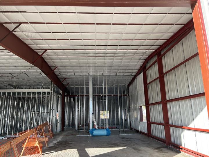 Insulated steel building with interior stud framing
