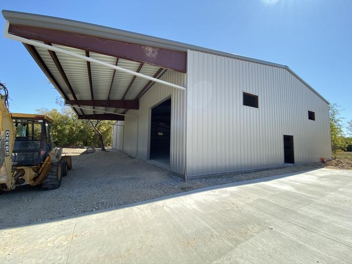Sheeted steel building with deep overhang