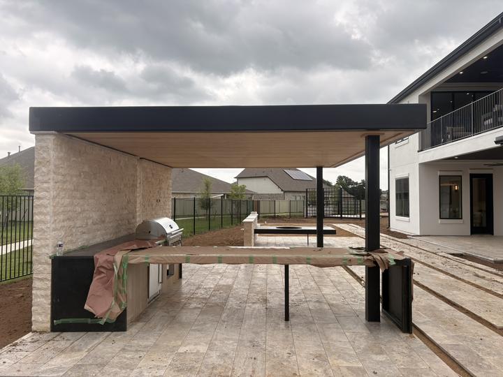 Flat steel roof over a grill and prep counter