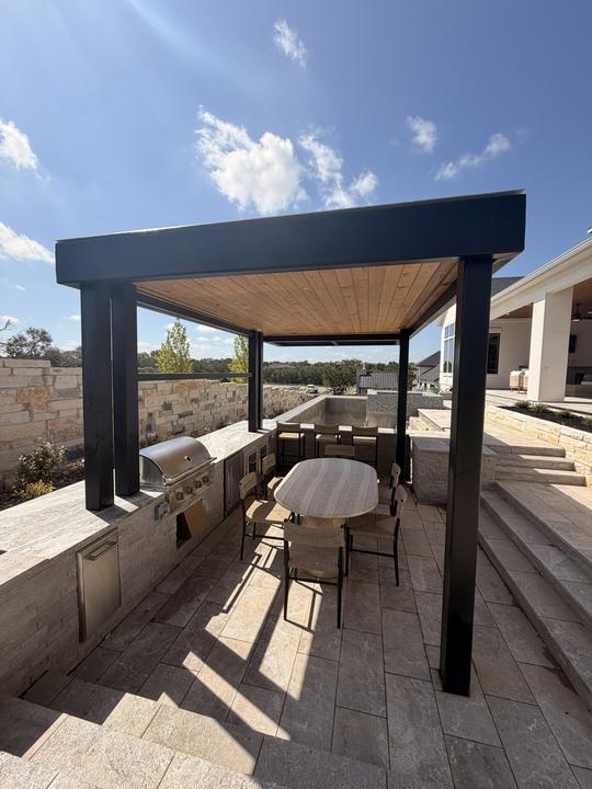 Pergola over an outdoor kitchen and dining area