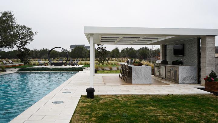 Poolside pergola over a full outdoor kitchen