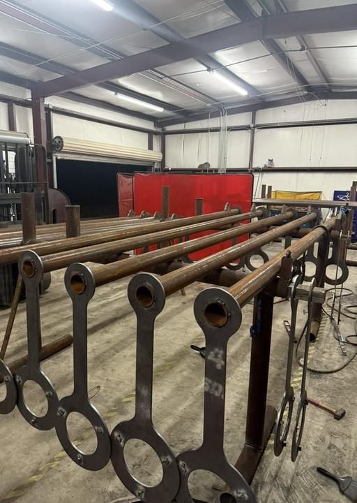 Pipe frames with lug plates lined up in the shop