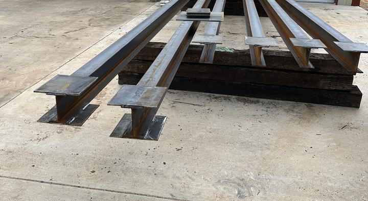 Steel columns with welded base and cap plates
