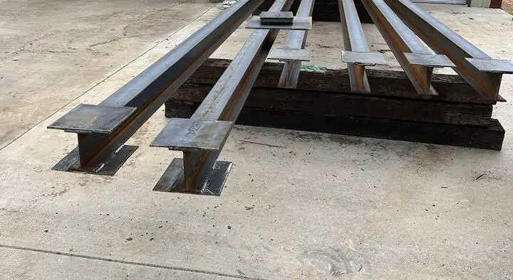 Steel columns with welded base and cap plates