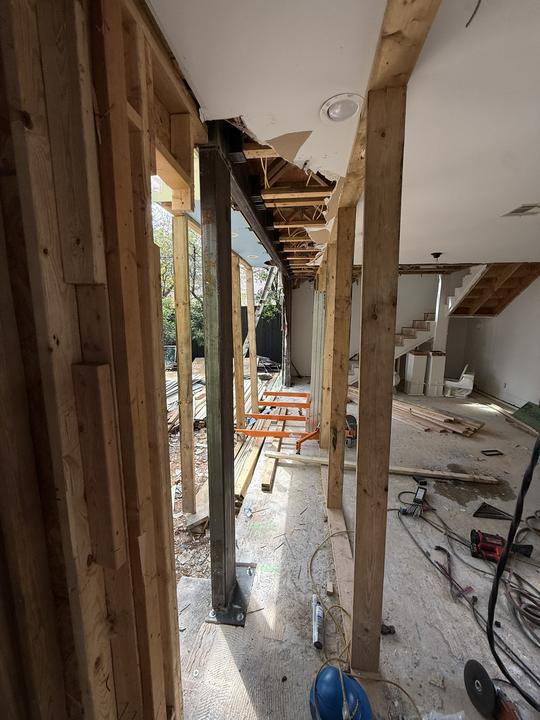 Steel column set between wood framing in a remodel